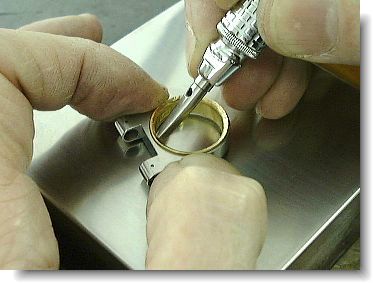 Hammering bezel into the blank with hammer hand piece